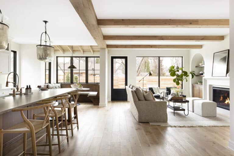 Bright open-concept living space with light wood ceiling and box beams, showcasing modern wood ceiling ideas with exposed box beam design.