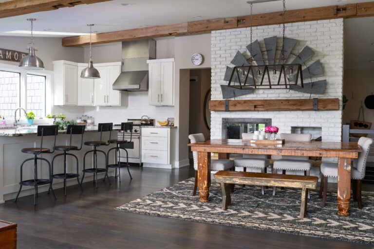 Modern farmhouse kitchen and dining area featuring salvaged wood beams, rustic dining table, and reclaimed wood accents—an inspiring example of creative wood projects in home design (NARI MN)