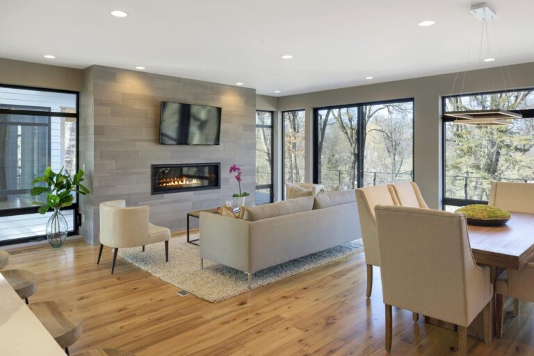 Open-concept living and dining area featuring reclaimed wood floors and clean modern finishes, highlighting the warmth and durability of the best wood flooring.