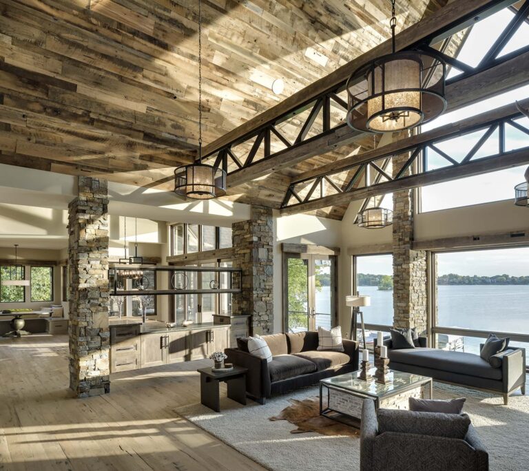 Luxury living room with reclaimed wood flooring, timber beams, and a wood ceiling that demonstrates how reclaimed materials create the best wood flooring for timeless interiors.
